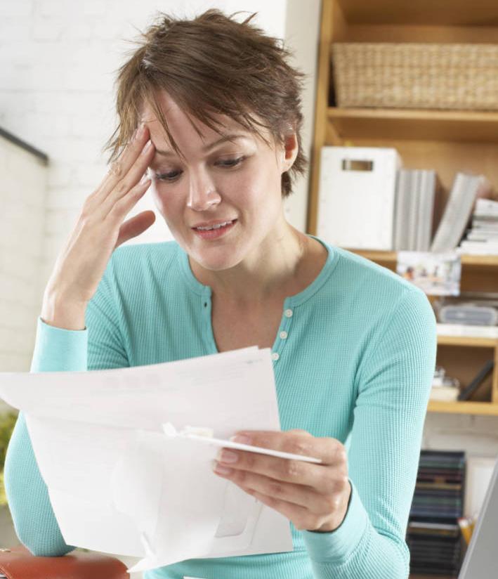 Woman Confused by Auto Insurance Papers
