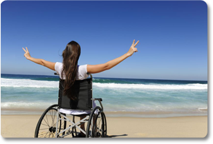 Woman in wheelchair on beach